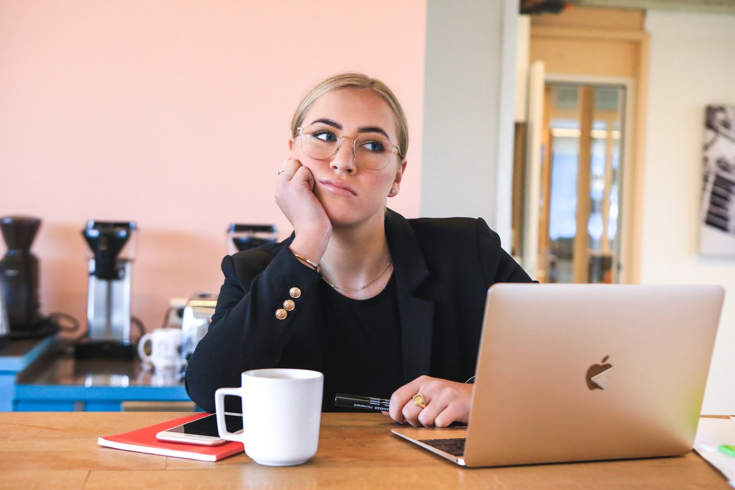 office woman in glasses holding chin